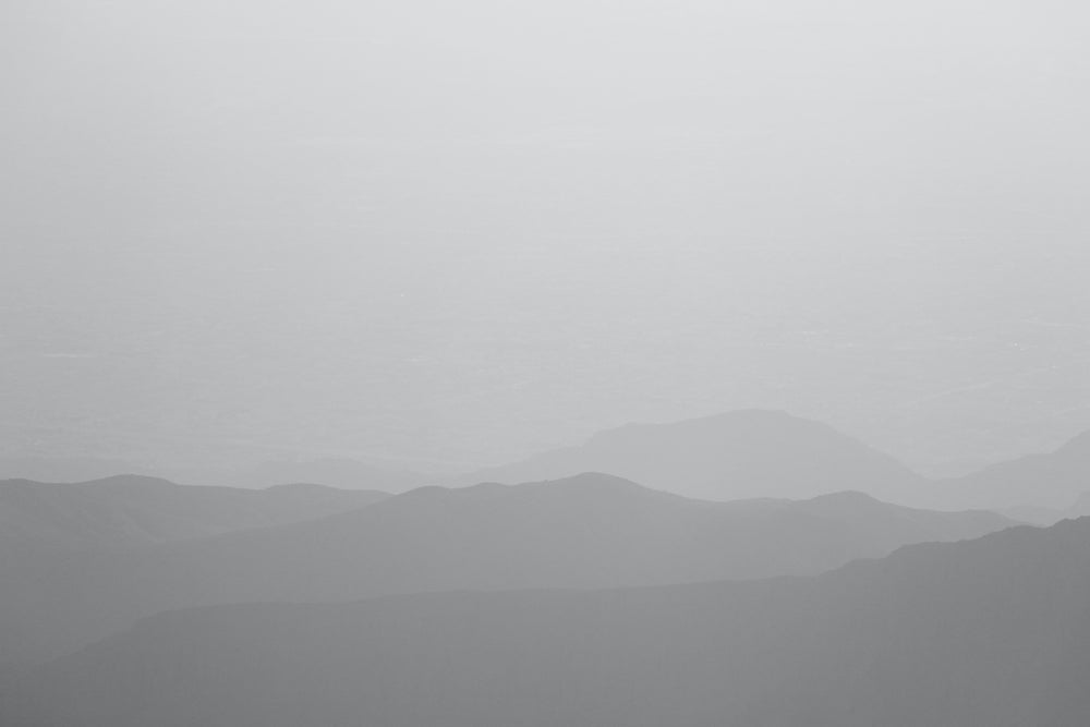 A foggy mountain landscape representing the Sinzia Nap Mat - Kijivu, celebrating African heritage and connections.