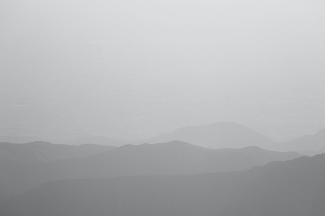 A foggy mountain landscape representing the Sinzia Nap Mat - Kijivu, celebrating African heritage and connections.