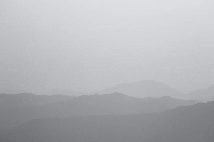 A foggy mountain landscape representing the Sinzia Nap Mat - Kijivu, celebrating African heritage and connections.